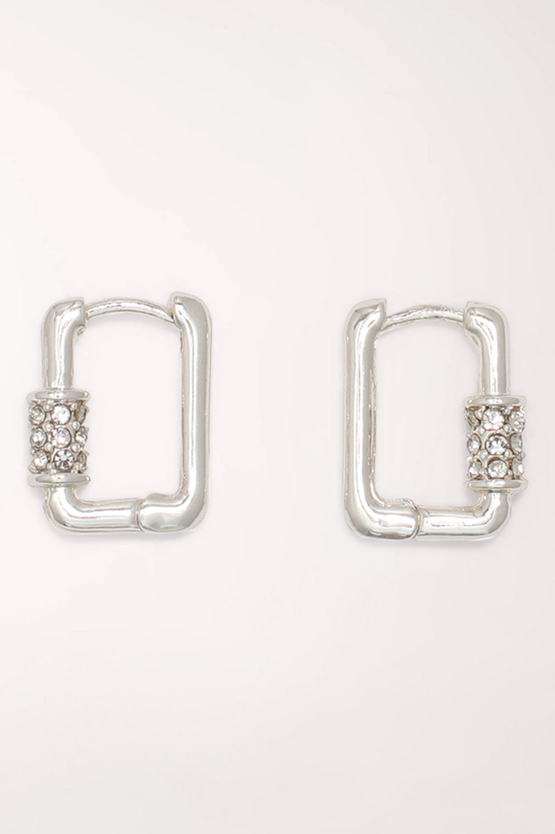Pair of Periwinkle Silver Crystal Huggie Hoop Earrings: small rectangular silver-tone huggie hoops with a band of clear pave crystals on one side.