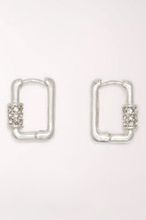 Pair of Periwinkle Silver Crystal Huggie Hoop Earrings: small rectangular silver-tone huggie hoops with a band of clear pave crystals on one side.