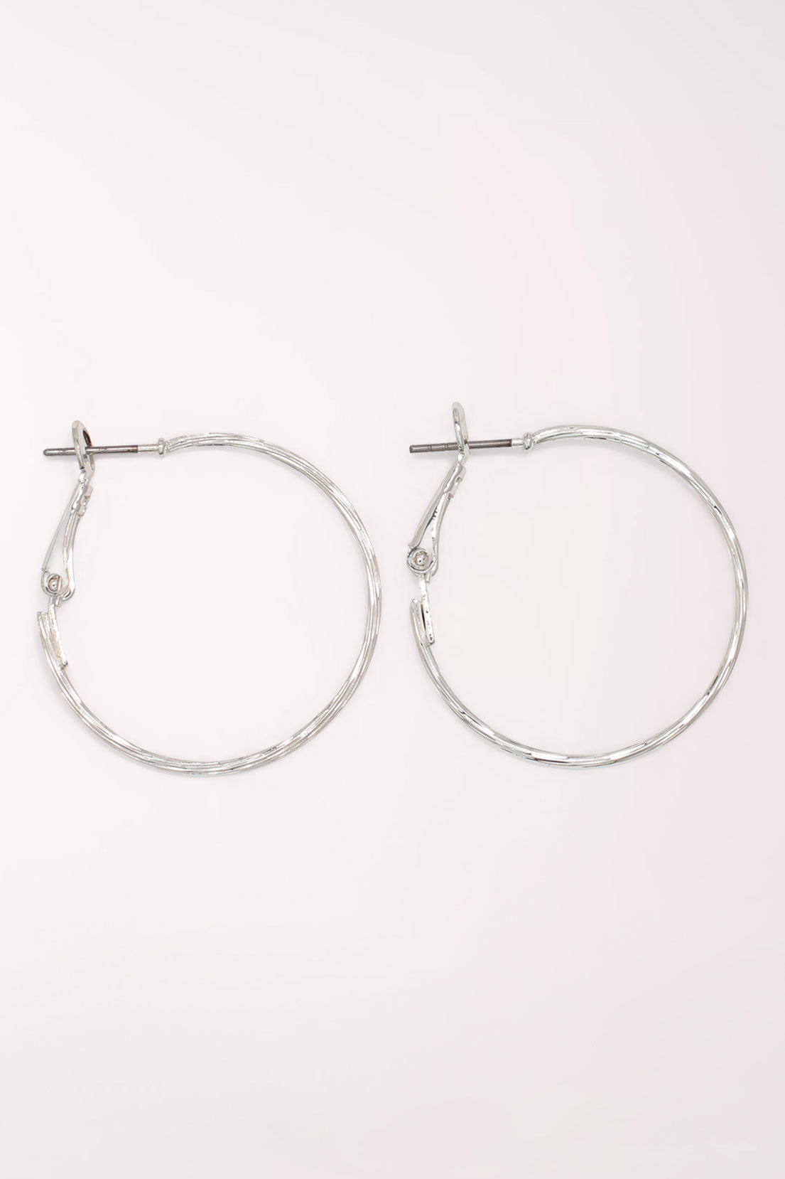 Pair of Periwinkle Silver Delicate Textured Hoop Earrings: thin silver-tone hoops with a lightly hammered texture and a snapback post closure.