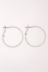Pair of Periwinkle Silver Delicate Textured Hoop Earrings: thin silver-tone hoops with a lightly hammered texture and a snapback post closure.