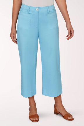 Person wearing light blue pants on a white background