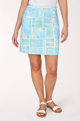 Person wearing a blue patterned skirt on a white background
