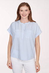 Woman wearing a blue and white striped shirt against a white background