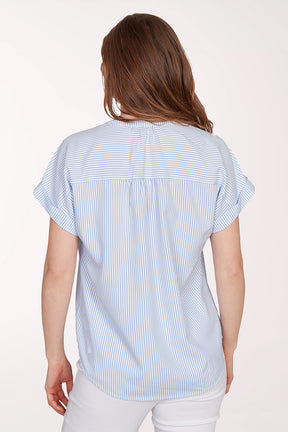 Woman wearing a blue and white striped shirt against a white background