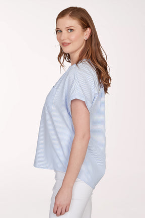 Woman wearing a blue and white striped shirt against a white background