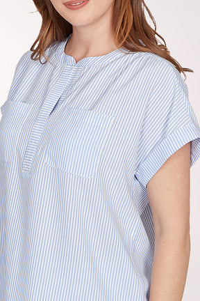Woman wearing a blue and white striped shirt against a white background