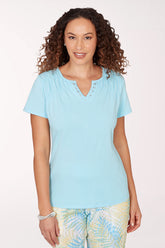 Woman wearing a light blue top with a white background