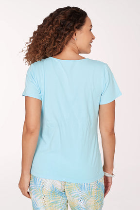 Woman wearing a light blue top with a white background