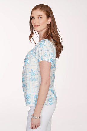 Woman wearing a light blue floral patterned top on a white background