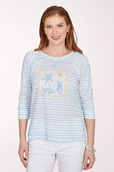 Woman wearing a light blue striped shirt with a floral design on a white background