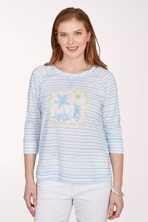 Woman wearing a light blue striped shirt with a floral design on a white background
