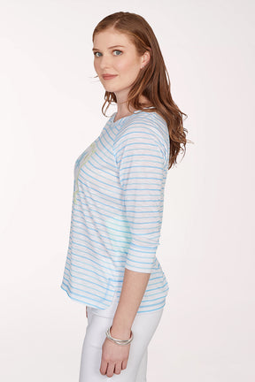 Woman wearing a light blue striped shirt with a floral design on a white background