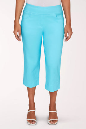 Person wearing bright blue capri pants on a white background