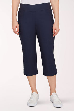 Person wearing navy blue capri pants on a white background