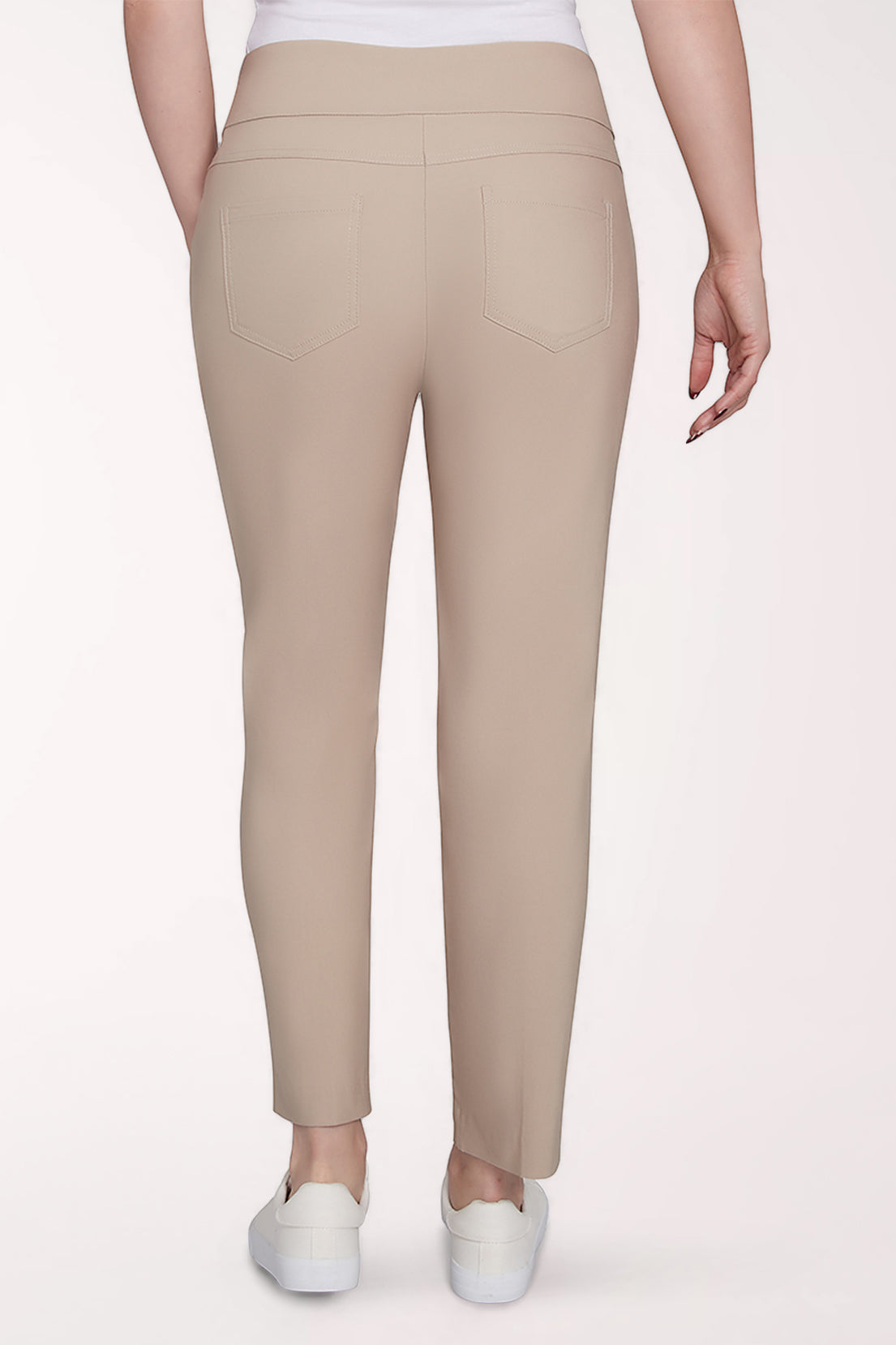 Beige leggings worn by a person on a white background