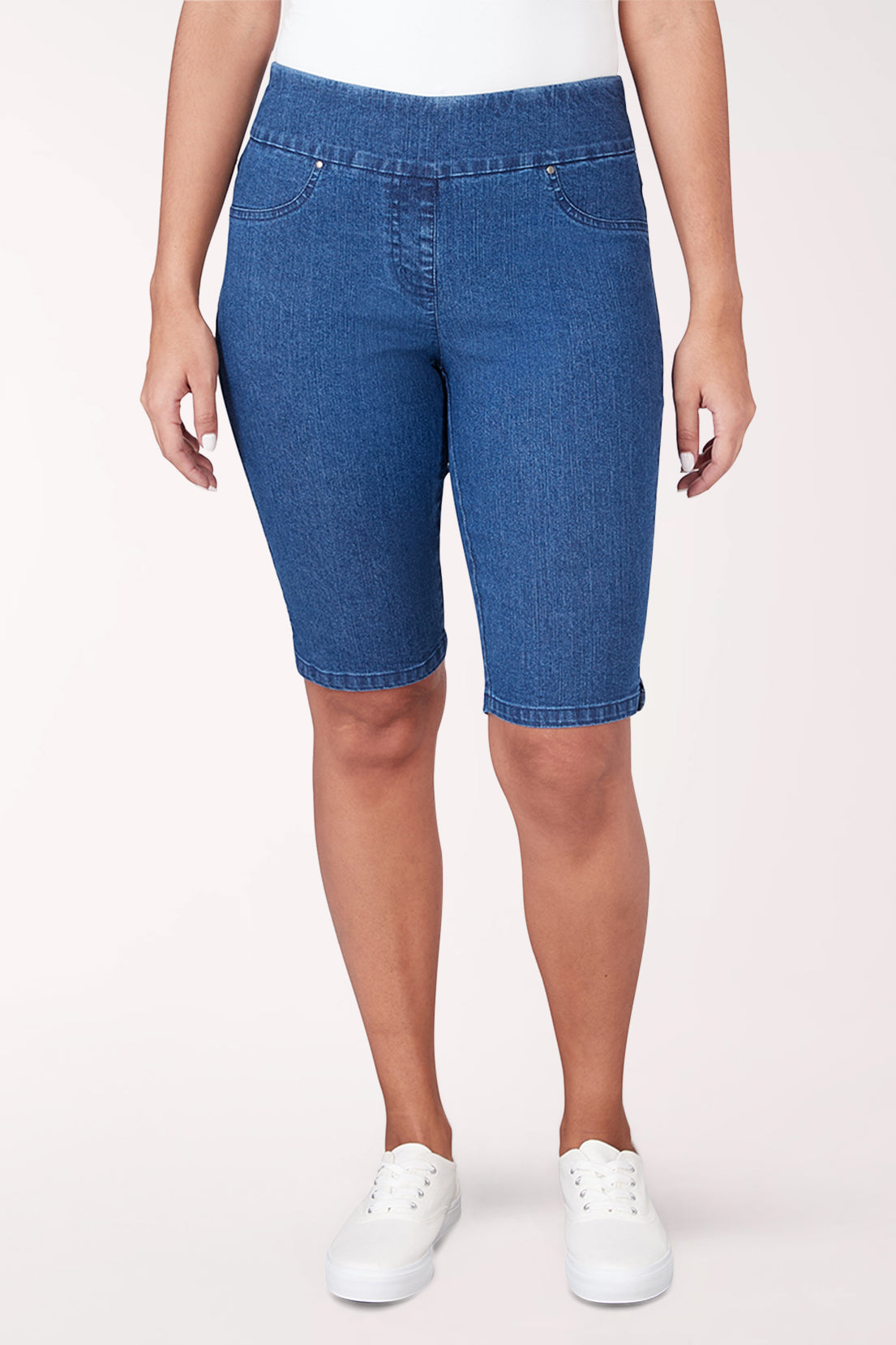 Blue denim shorts worn by a person on a white background