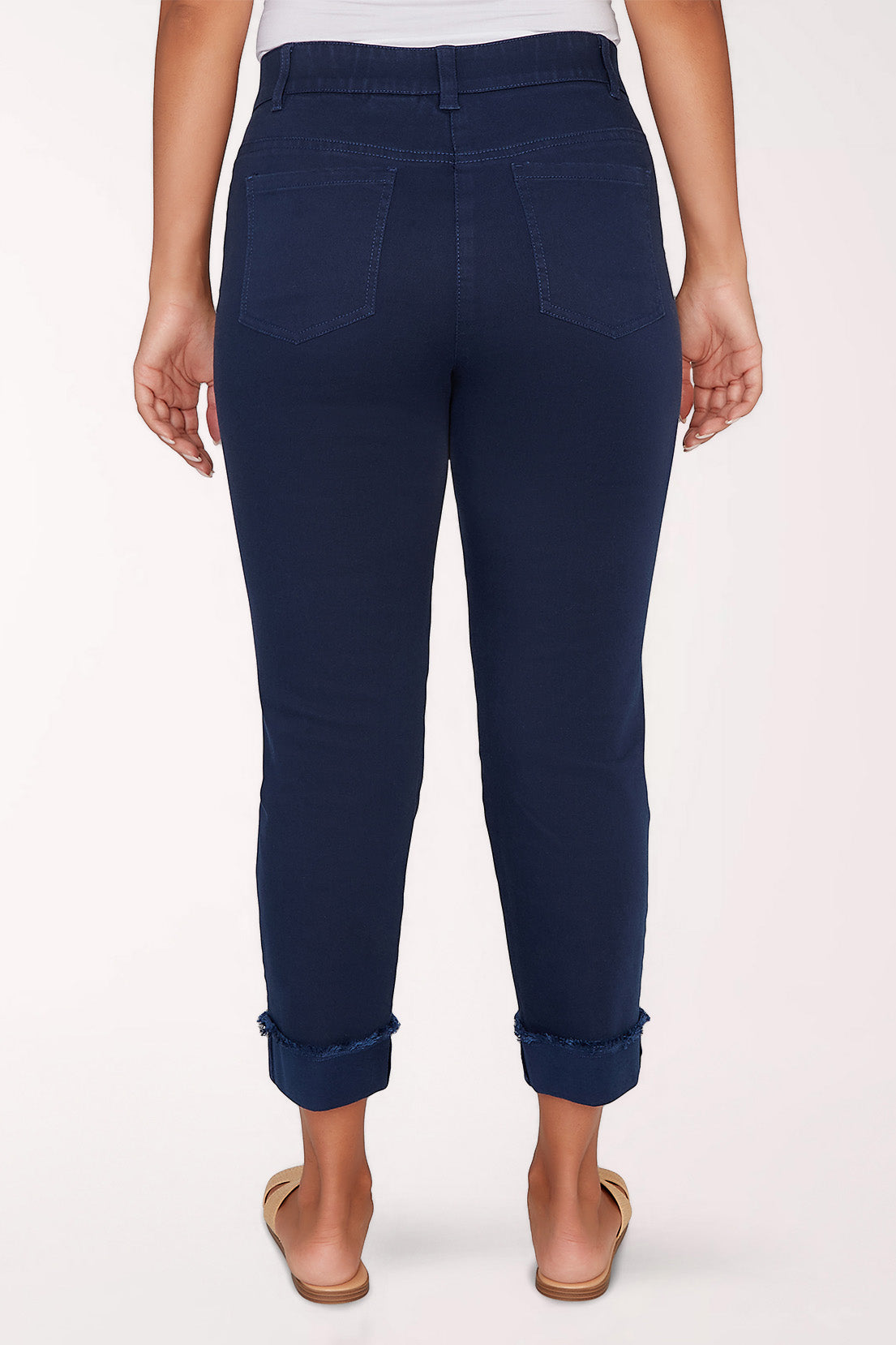 Navy blue pants worn by a person on a white background