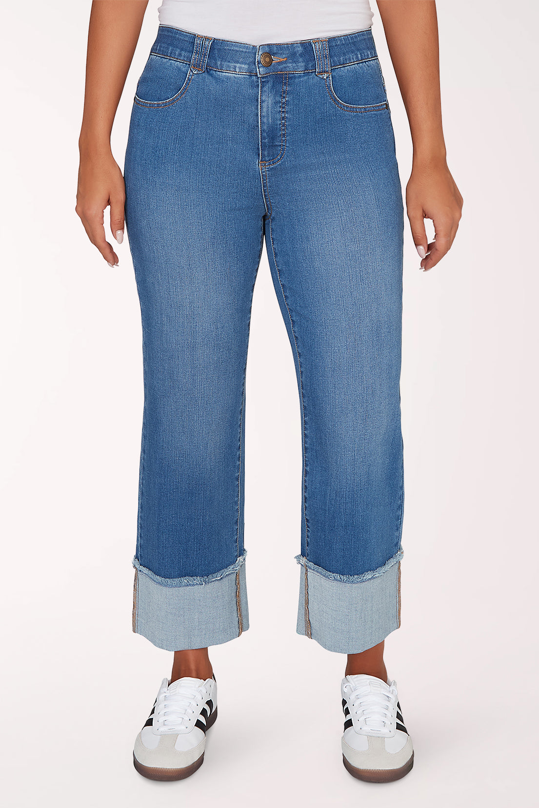 Person wearing blue jeans with a white background