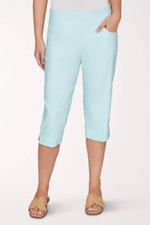 A light blue capri pant worn by a woman on a light pink background