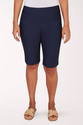 Person wearing navy blue shorts on a white background