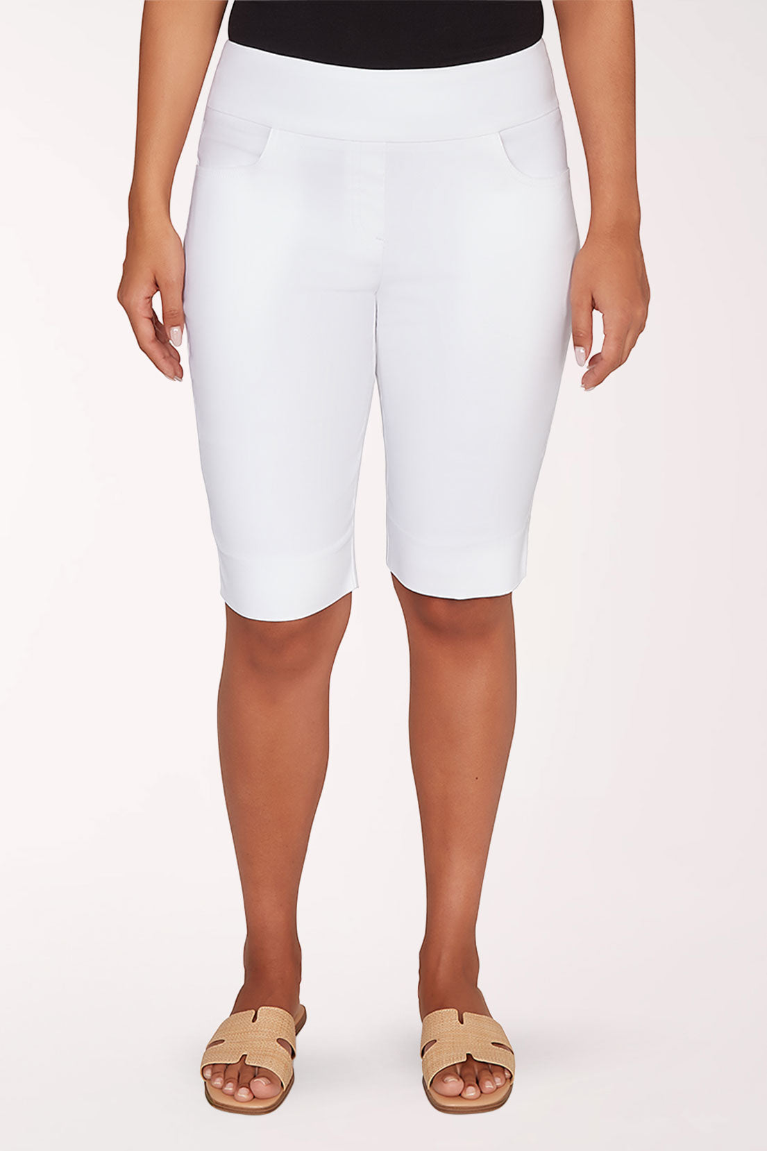 Person wearing white shorts on a plain background