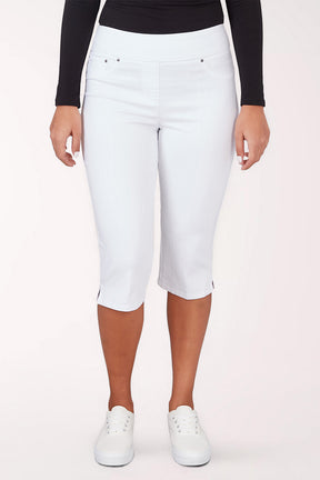 A woman wearing cropped white pants.