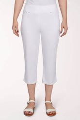 White capri pants worn by a person on a light pink background