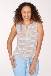 Woman wearing a striped sleeveless top and light blue jeans on a white background