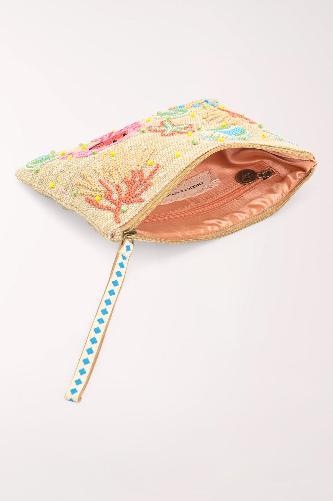 A rectangular zip pouch with a beige woven base, decorated with colorful beaded sea-themed motifs including a pink crab, blue starfish, green shells, and coral, featuring a blue and white patterned zipper pull.