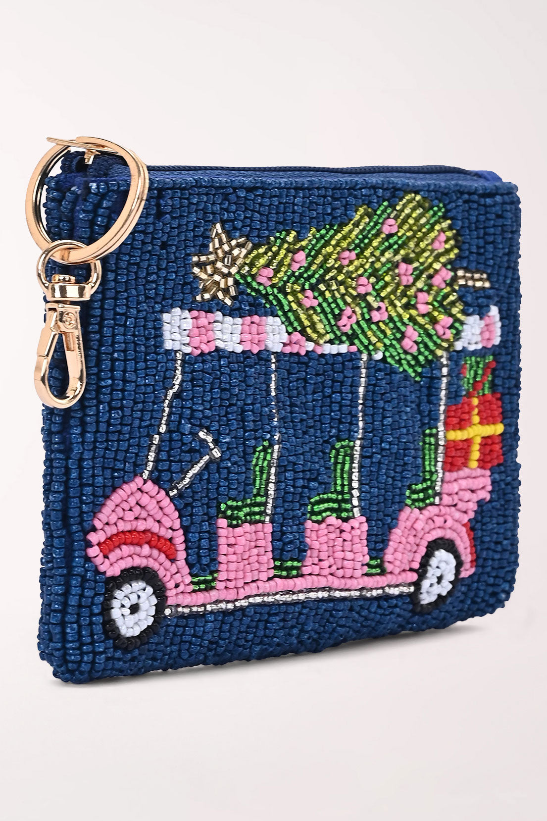 Angled view of the Merry Carting beaded pouch showing the pink golf cart, Christmas tree and gift in detail.