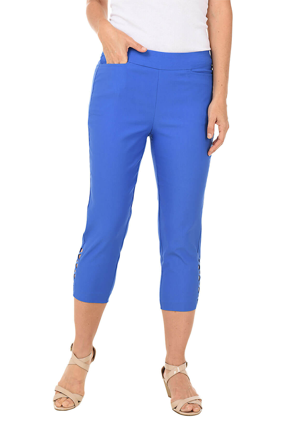 A woman wearing a blue capri pant against a white background