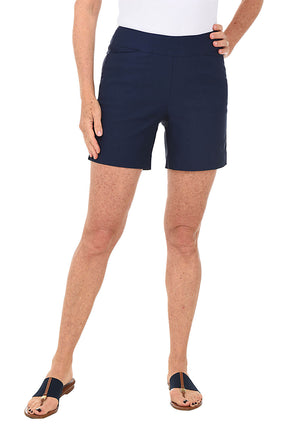 Person wearing navy shorts on a white background