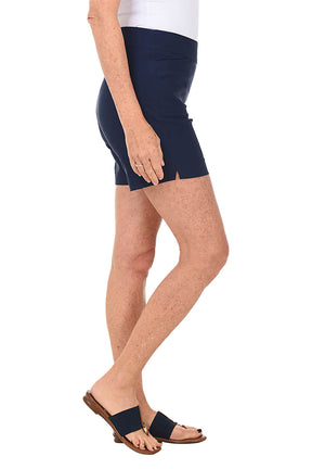 Navy blue shorts worn by a person on a white background