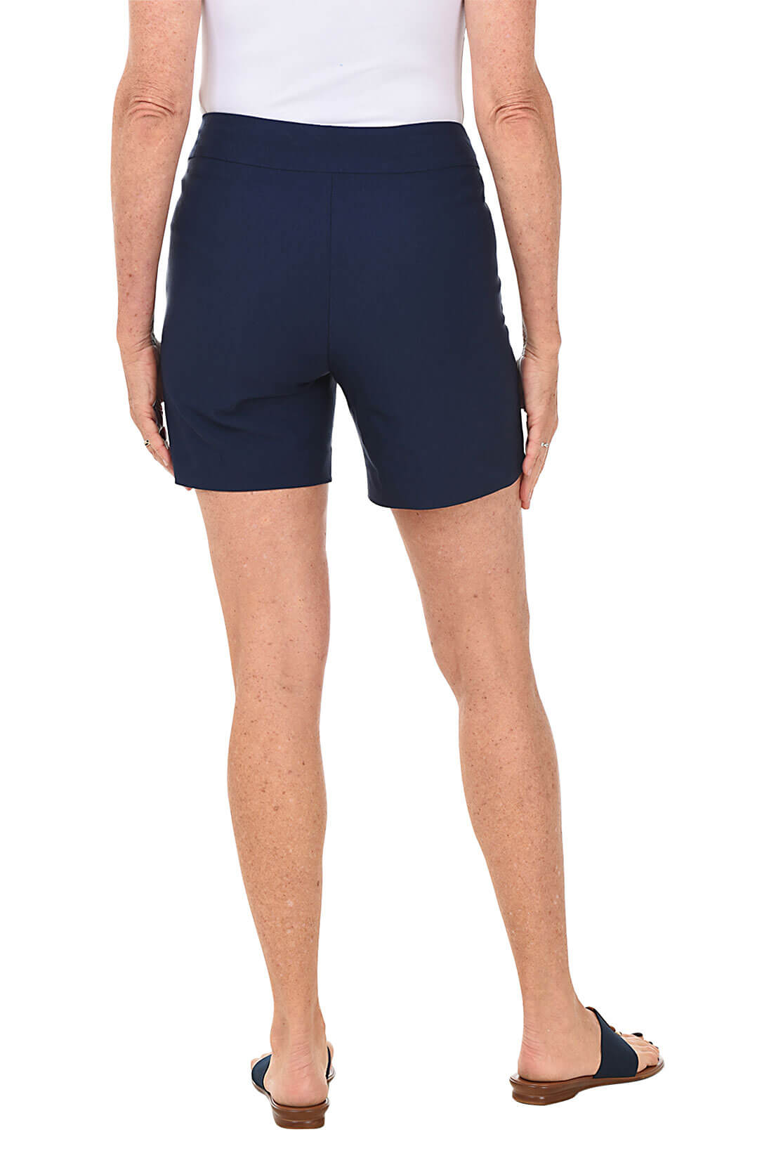 Person wearing navy shorts on a white background