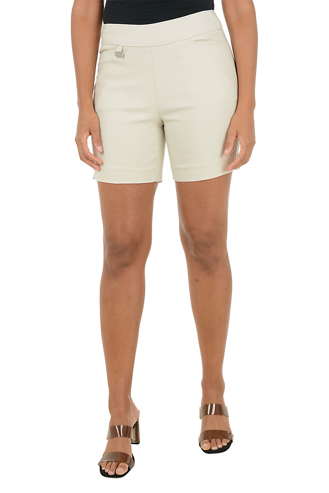 Beige shorts worn by a person on a white background