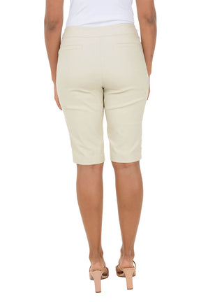 Beige shorts worn by a person on a white background
