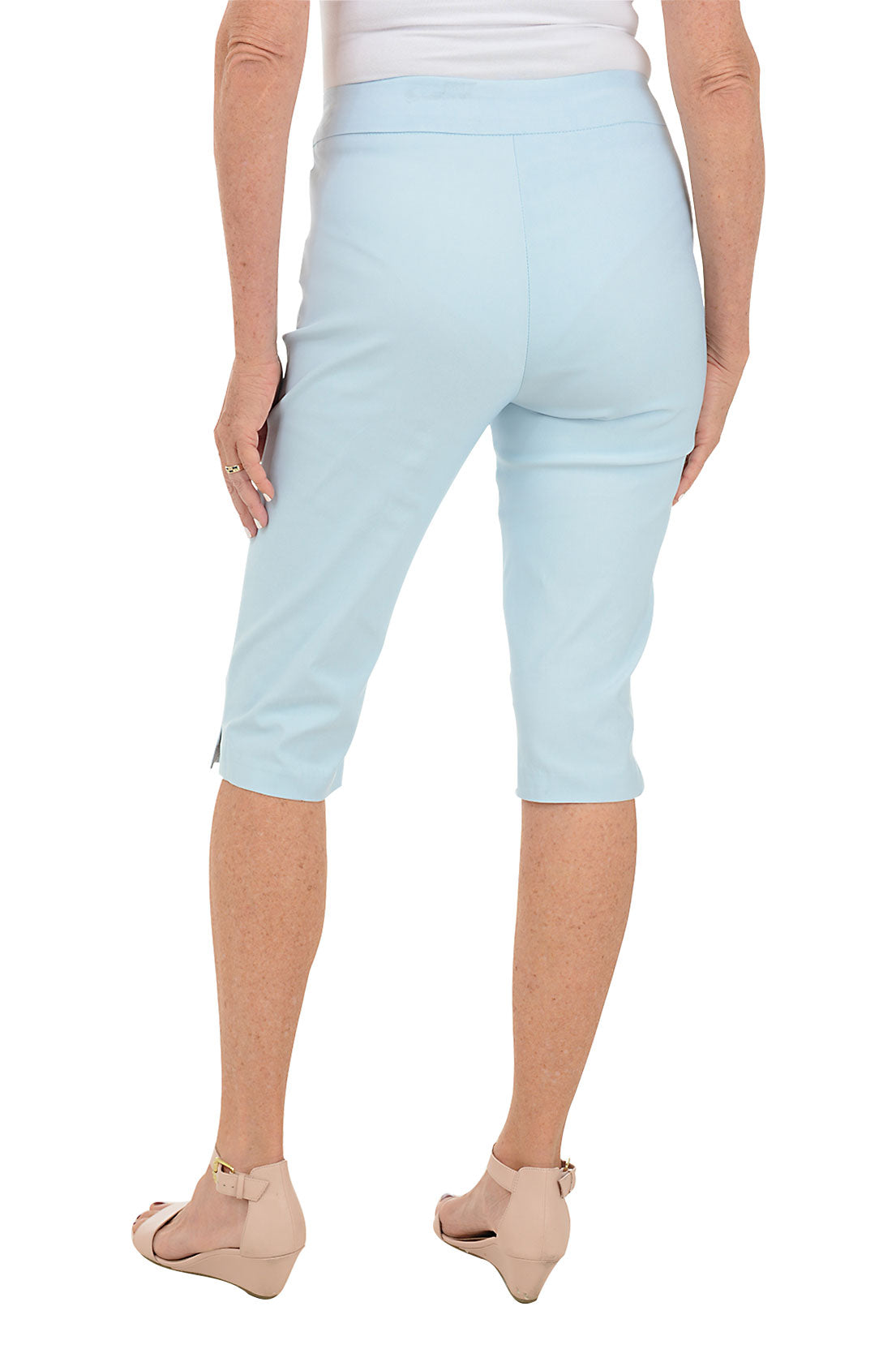 Light blue capri pants worn by a person on a white background. Back shot.