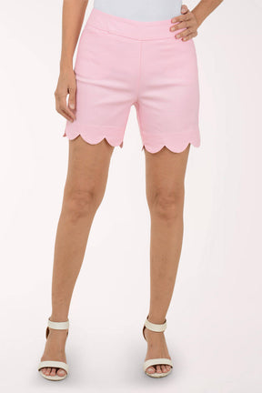 Pink shorts with scalloped hem on a white background