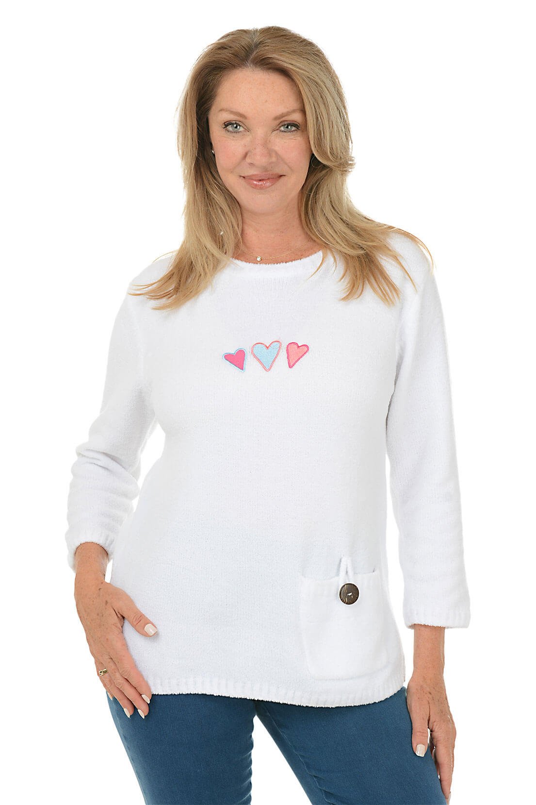 Woman wearing a white sweater with heart designs on a white background