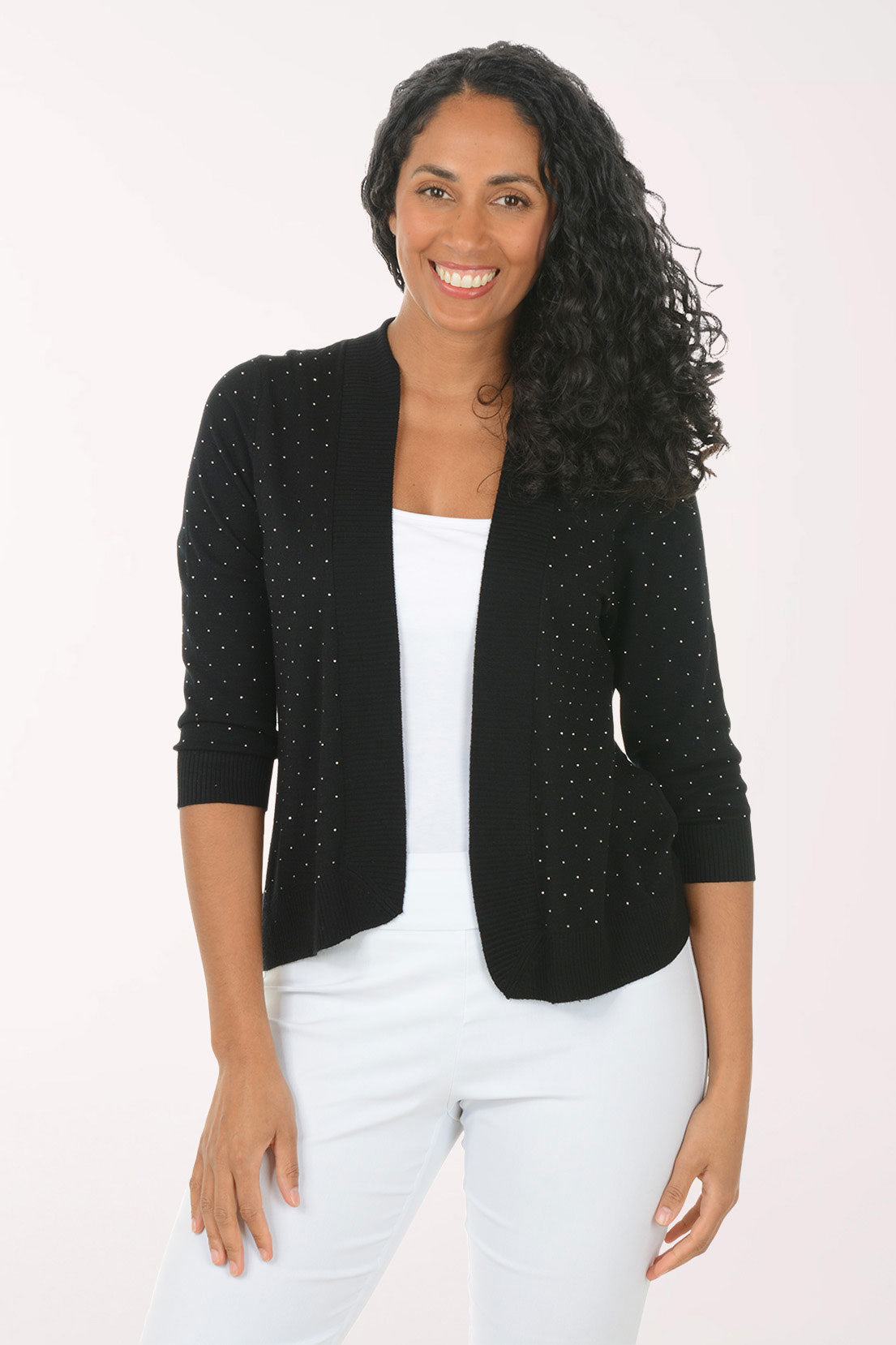 Woman wearing a black cardigan with sequin details on a white background