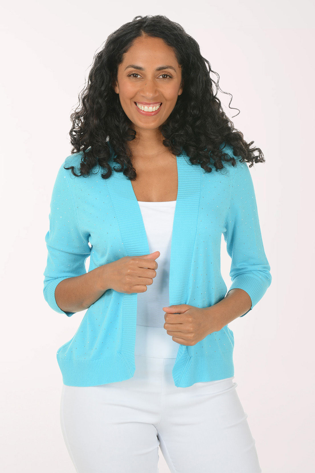 Woman wearing a light blue cardigan over a white top on a white background
