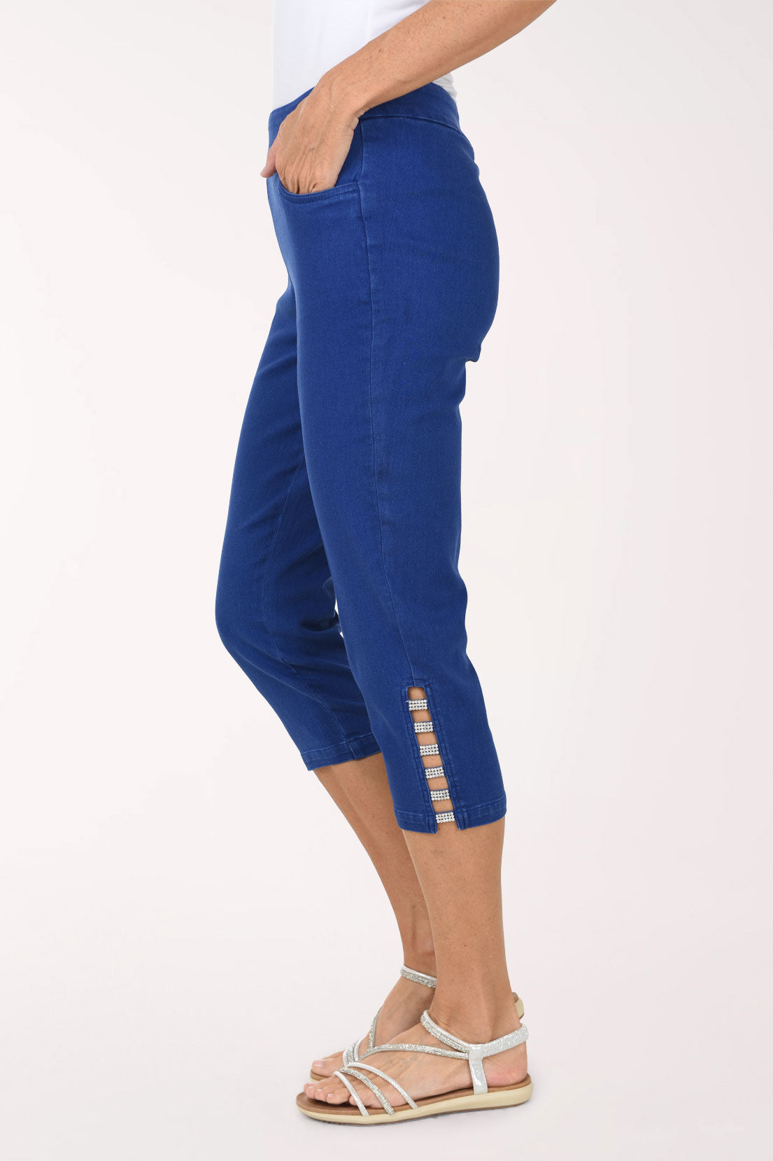 Side view of the Crystal Lattice Hem Denim Capri Pant showing the crystal-studded lattice cutout at the outer hem and the capri length.