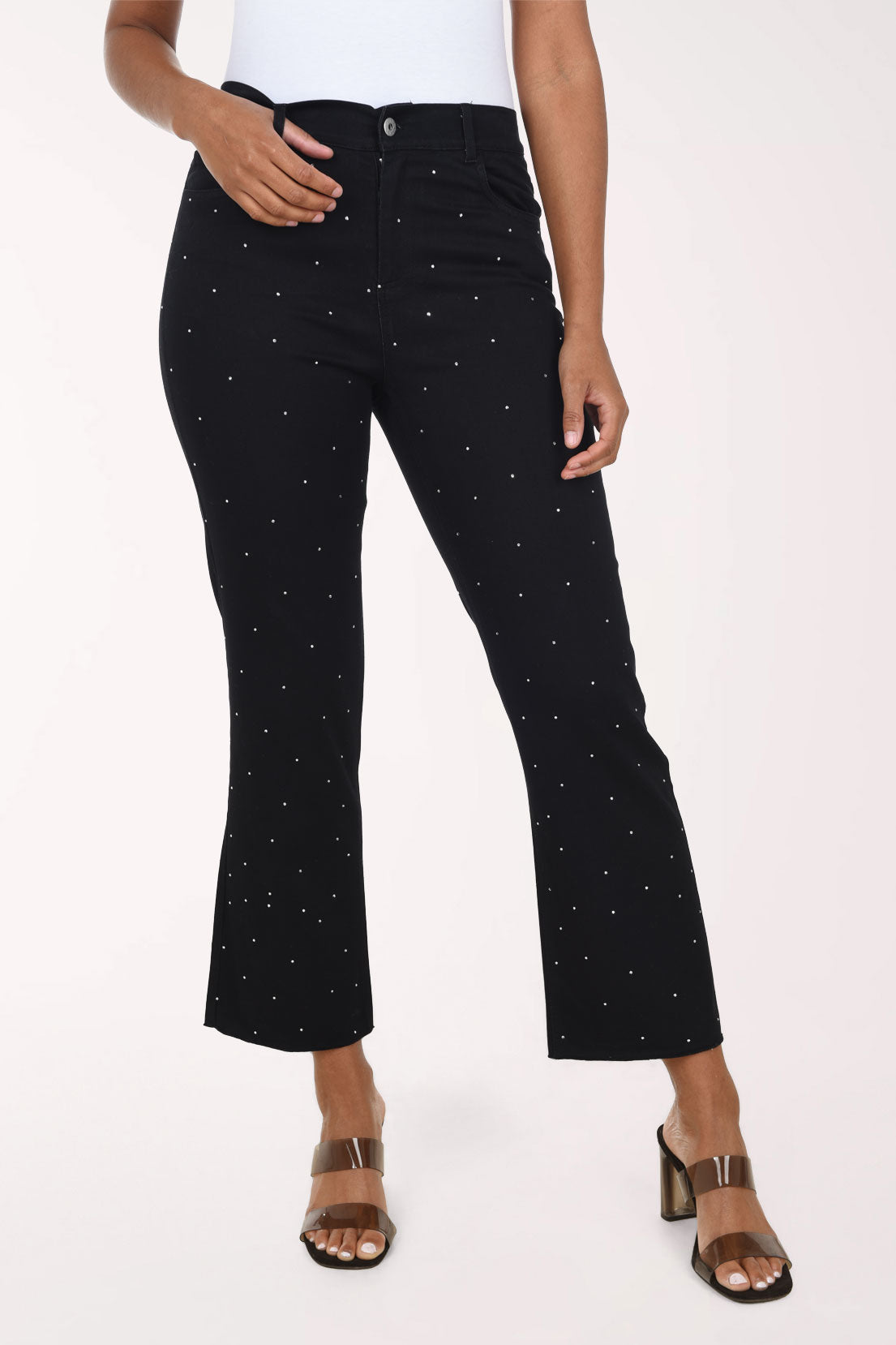 Woman wearing a black crop denim pant with all over jewels 