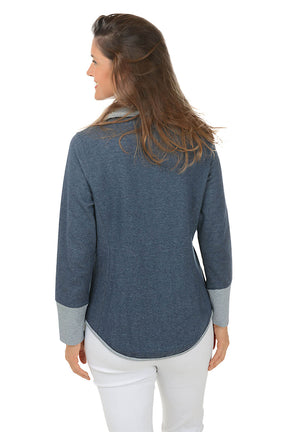 Woman wearing a blue zip-up hoodie with a white background. Back shot.