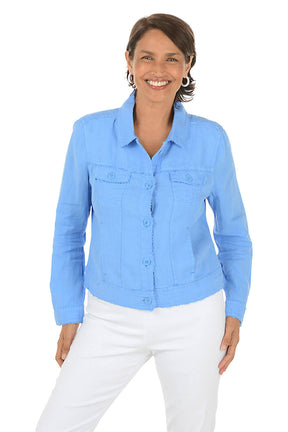 Woman wearing a periwinkle denim shirt and white pants on a white background