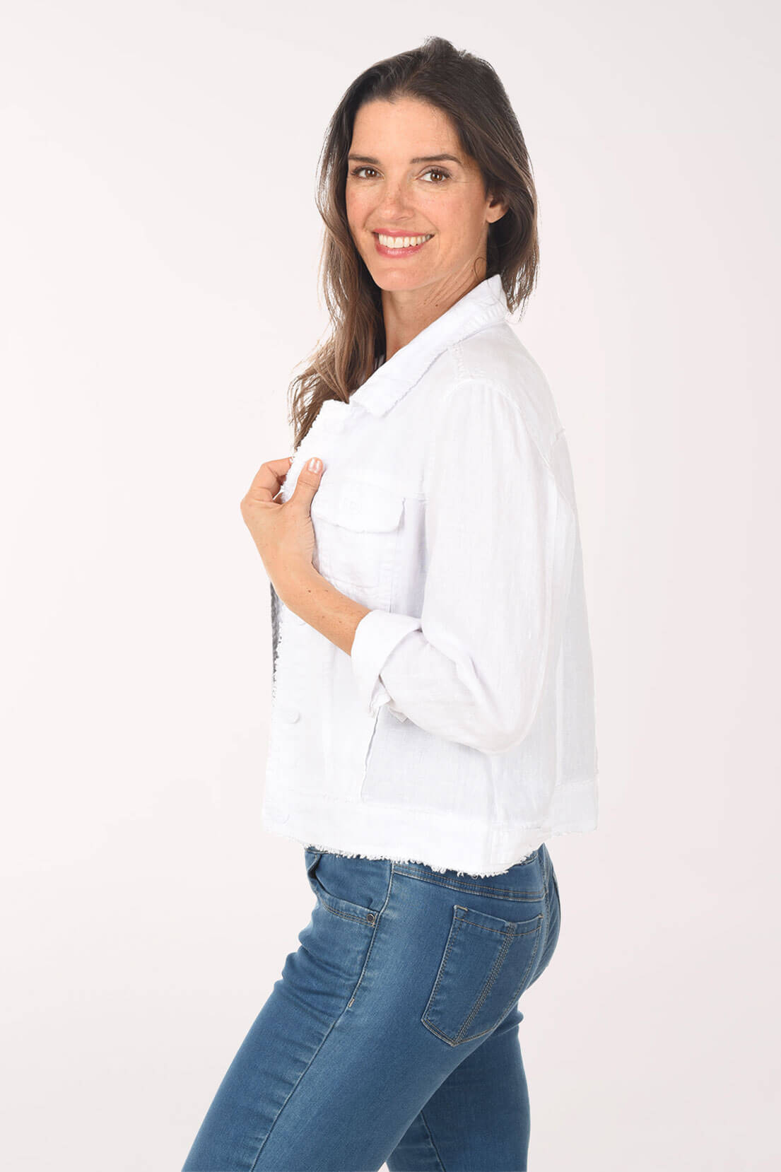 Woman wearing a white shirt and blue jeans on a white background
