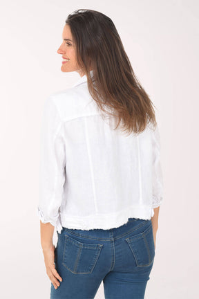 Woman wearing a white blouse and blue jeans on a white background