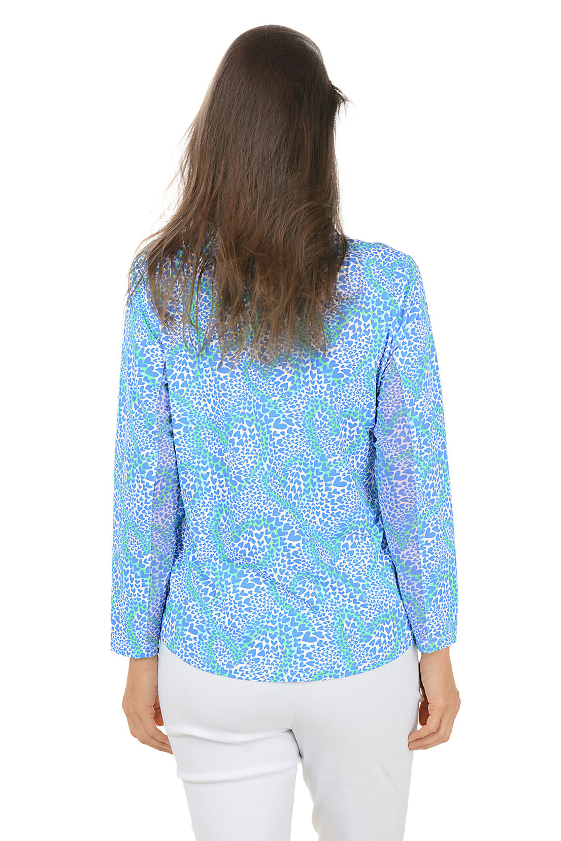 Woman wearing a blue patterned long-sleeve top on a white background. Side shot. Back shot.