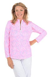 Woman wearing a pink floral long-sleeve top on a white background.
