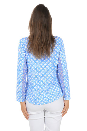 Woman wearing a blue patterned long-sleeve shirt on a white background. Back shot.